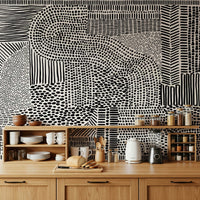 Black And White Maze wallpaper mural as a backsplash above wood kitchen counters with dishes