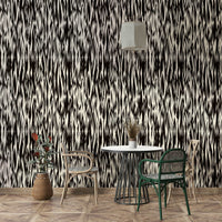 A bedroom decorated with a black wallpaper

