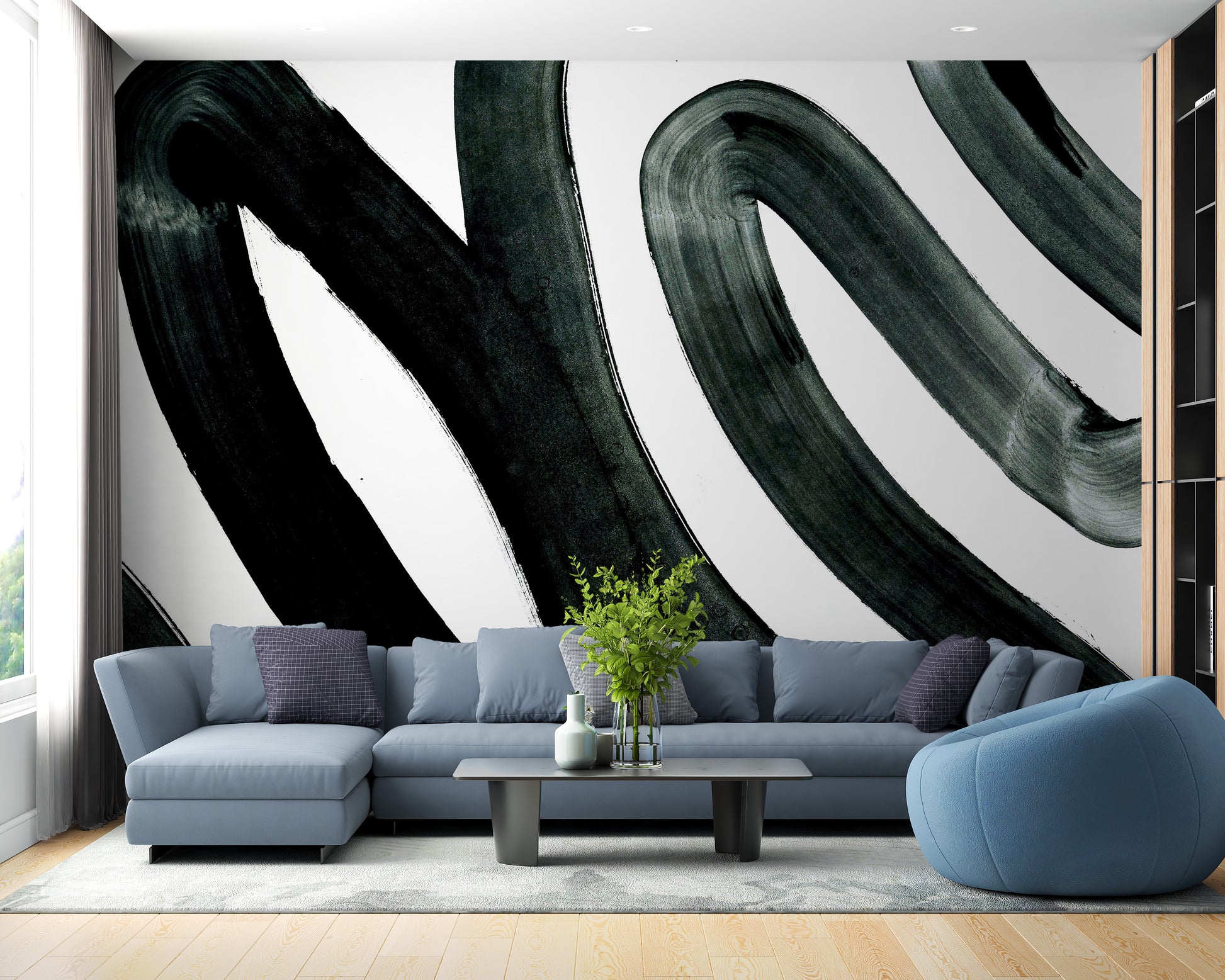 Black Brush Stroke wallpaper mural of bold black swirls on white behind a powder-blue sectional sofa in a living room