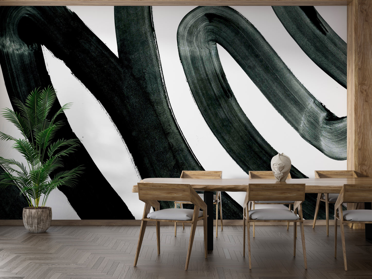 Black Brush Stroke wallpaper mural of black swirling brushstrokes on white in a dining room with wood table and tall palm