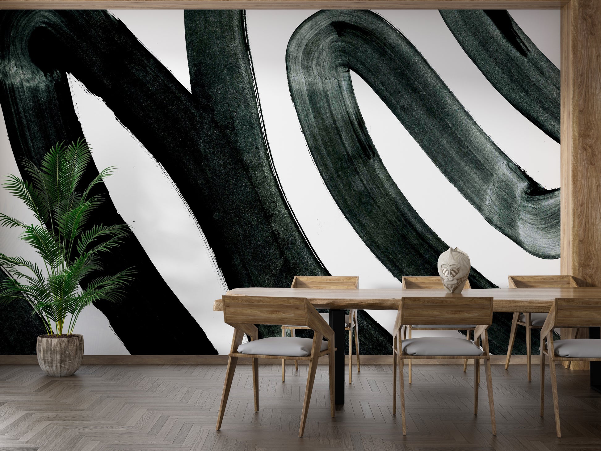 Black Brush Stroke wallpaper mural of black swirling brushstrokes on white in a dining room with wood table and tall palm