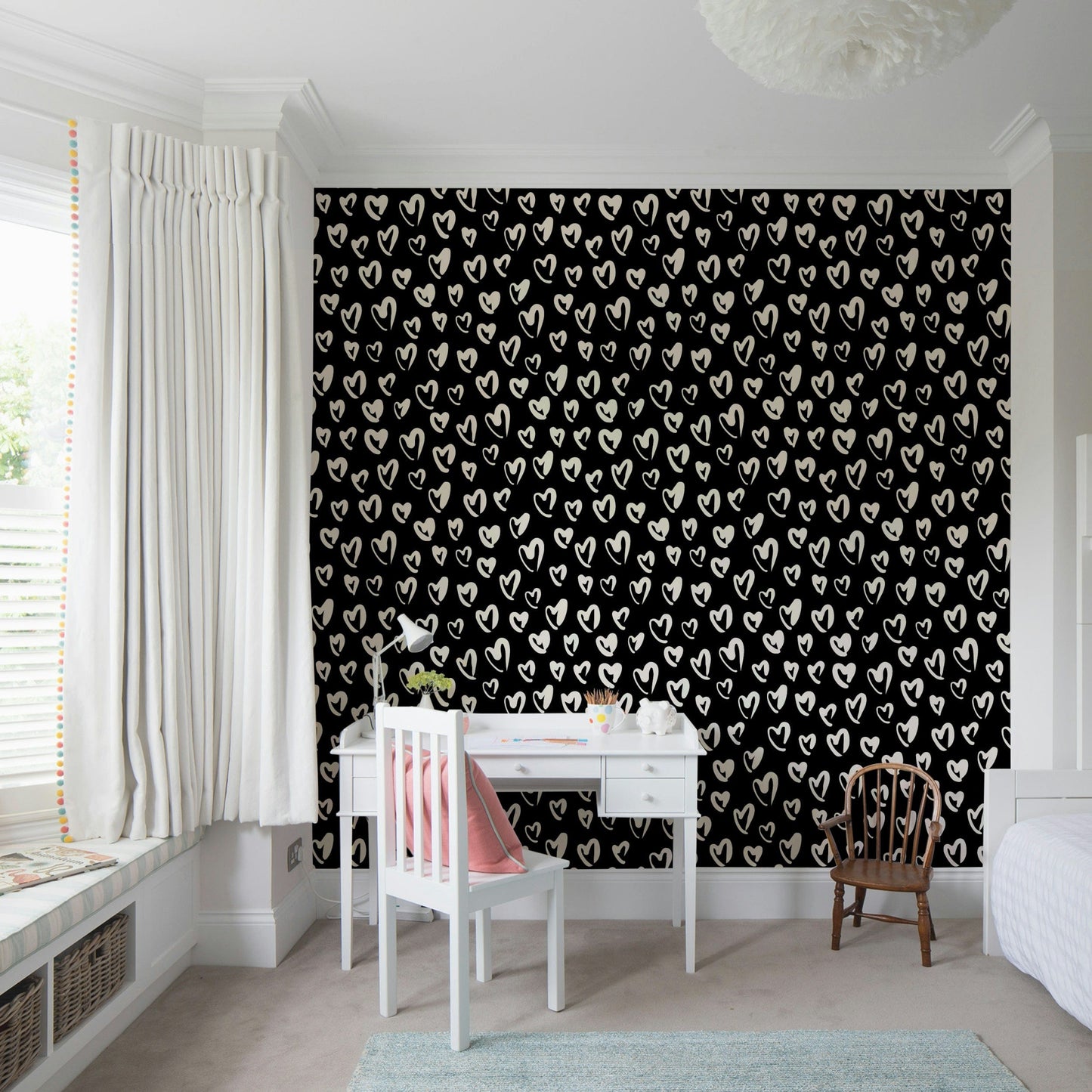 Whimsical playroom interior with heart motif wallpaper
