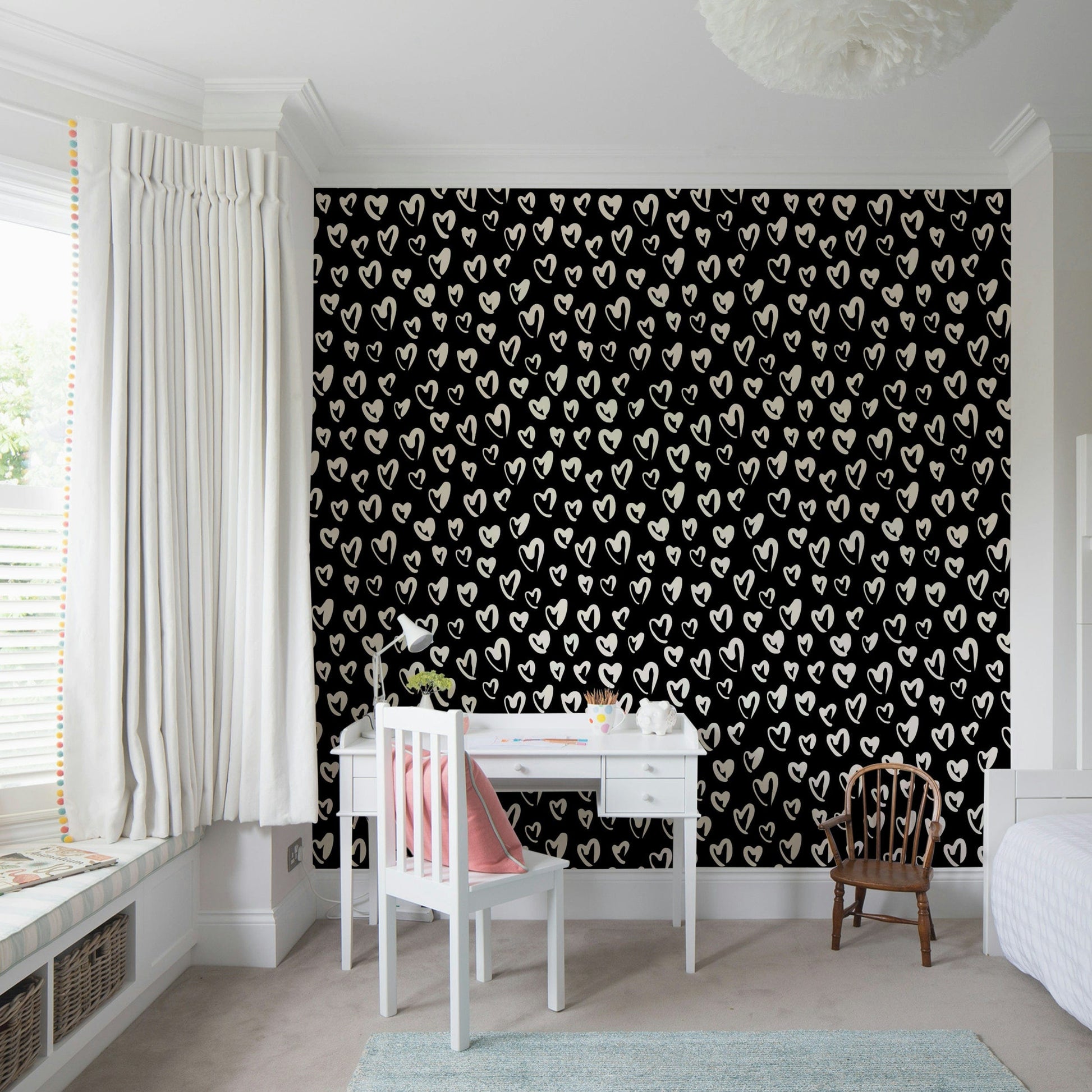 Whimsical playroom interior with heart motif wallpaper
