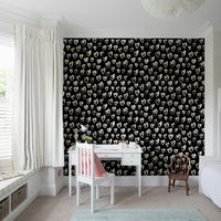 Whimsical playroom interior with heart motif wallpaper
