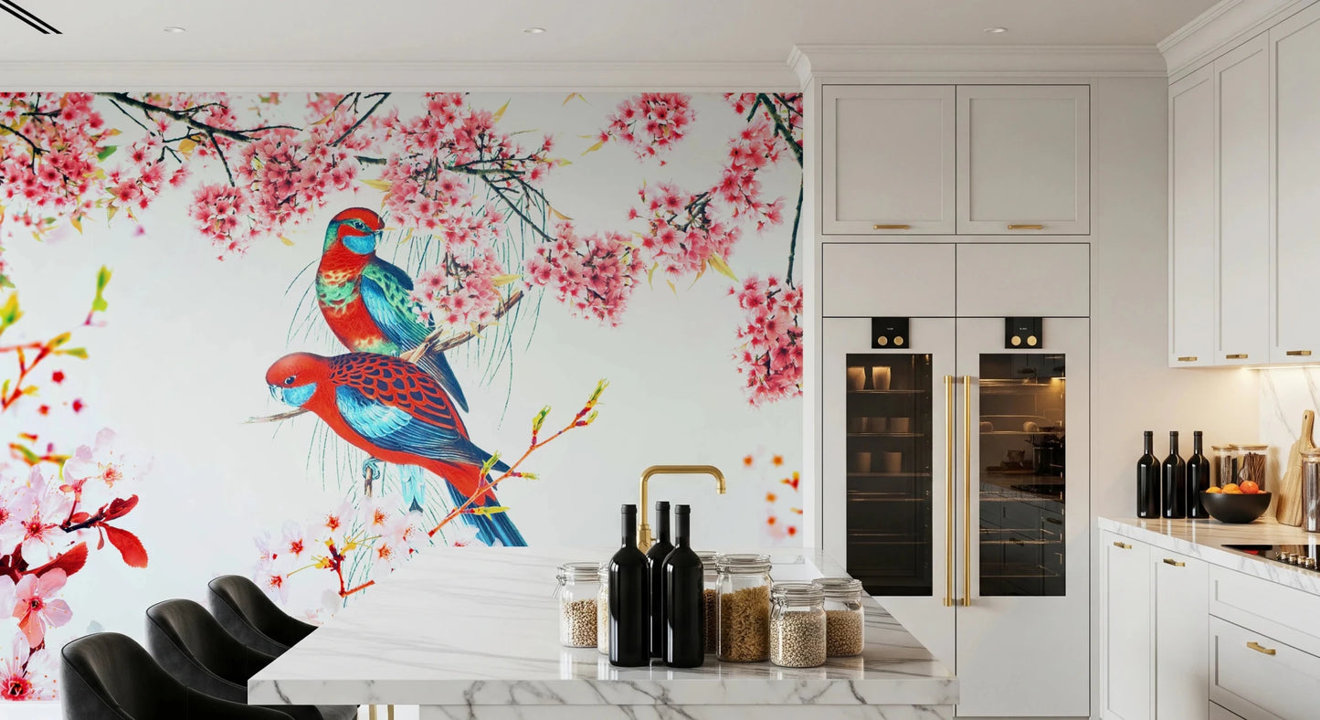 Blossom Birds wallpaper mural of parrots and pink flowers behind a white marble kitchen island and bar stools