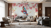 Blossom Birds wallpaper mural with parrots and pink blossoms behind grey sofas and a gold chandelier