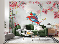 Blossom Birds wallpaper mural of parrots and blossoms behind a green velvet sofa with a tall cactus