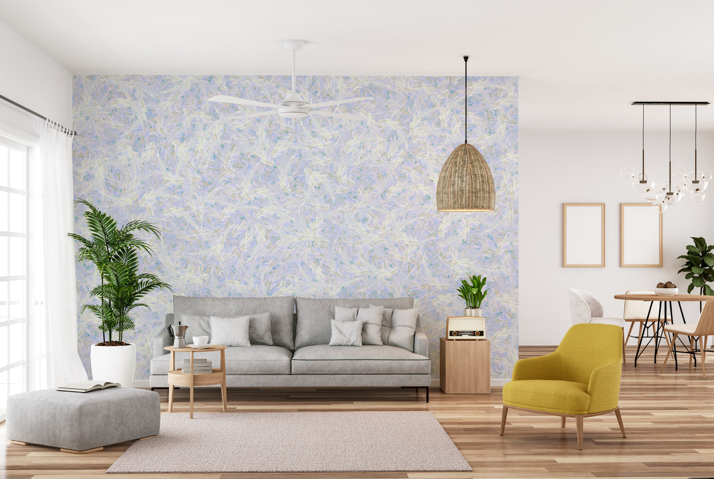 Blue Dancing Leaves Lila Azur wallpaper mural behind a grey sofa and mustard armchair in a living room