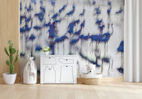 Flamingo Mirage wallpaper mural of blurred blue flamingos behind a white dresser and teddy bear in a nursery