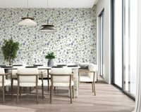 Soft blue butterfly wallpaper in an apartment bedroom with neutral bedding.