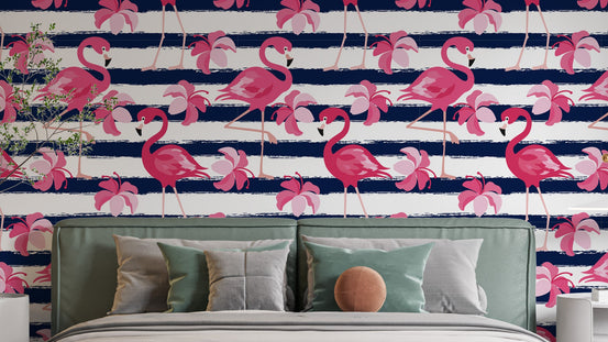 Blue Stripes & Pink Flamingo wallpaper on navy and white stripes behind a sage upholstered headboard in a bedroom