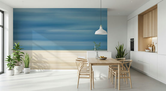Blurred Beach Serenity wallpaper mural of abstract blue sea and pale sand in a kitchen with light wood dining table