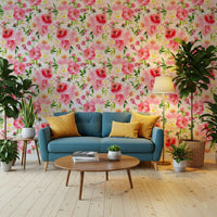 Blush Bloom Watercolor wallpaper behind a teal sofa with yellow pillows and leafy plants