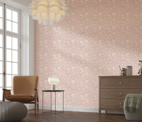 A minimalist blush wallpaper decorated with small blooming flowers for a serene spring look.