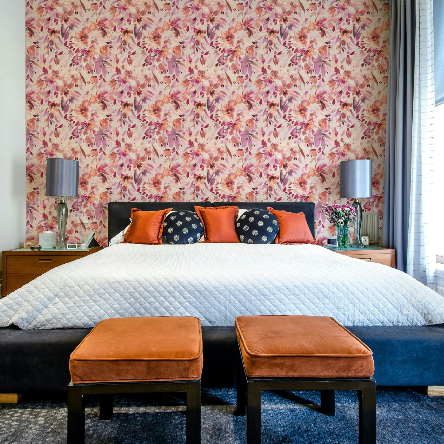 Coral and blush flowers on tropical-style wall

