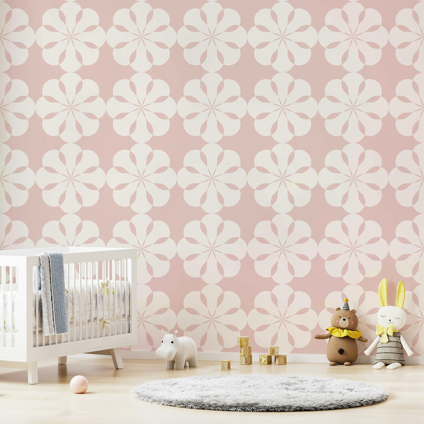 Soft pink geometric flower wallpaper for nursery walls.
