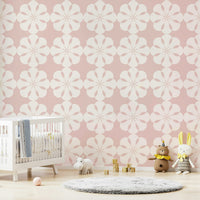 Soft pink geometric flower wallpaper for nursery walls.
