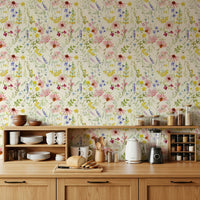 Blush floral meadow wallpaper behind sofa, modern home styling with delicate blooms