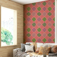 A damask-style print with pink and green tiles.

