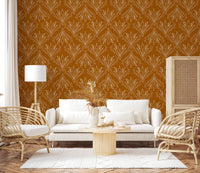Boho Art Nouveau Folk Floral Mustard Gold wallpaper behind a white sofa and rattan armchairs in a living room