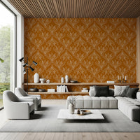 Boho Art Nouveau Folk Floral Mustard Gold wallpaper above a wood shelf and grey sectional in a living room