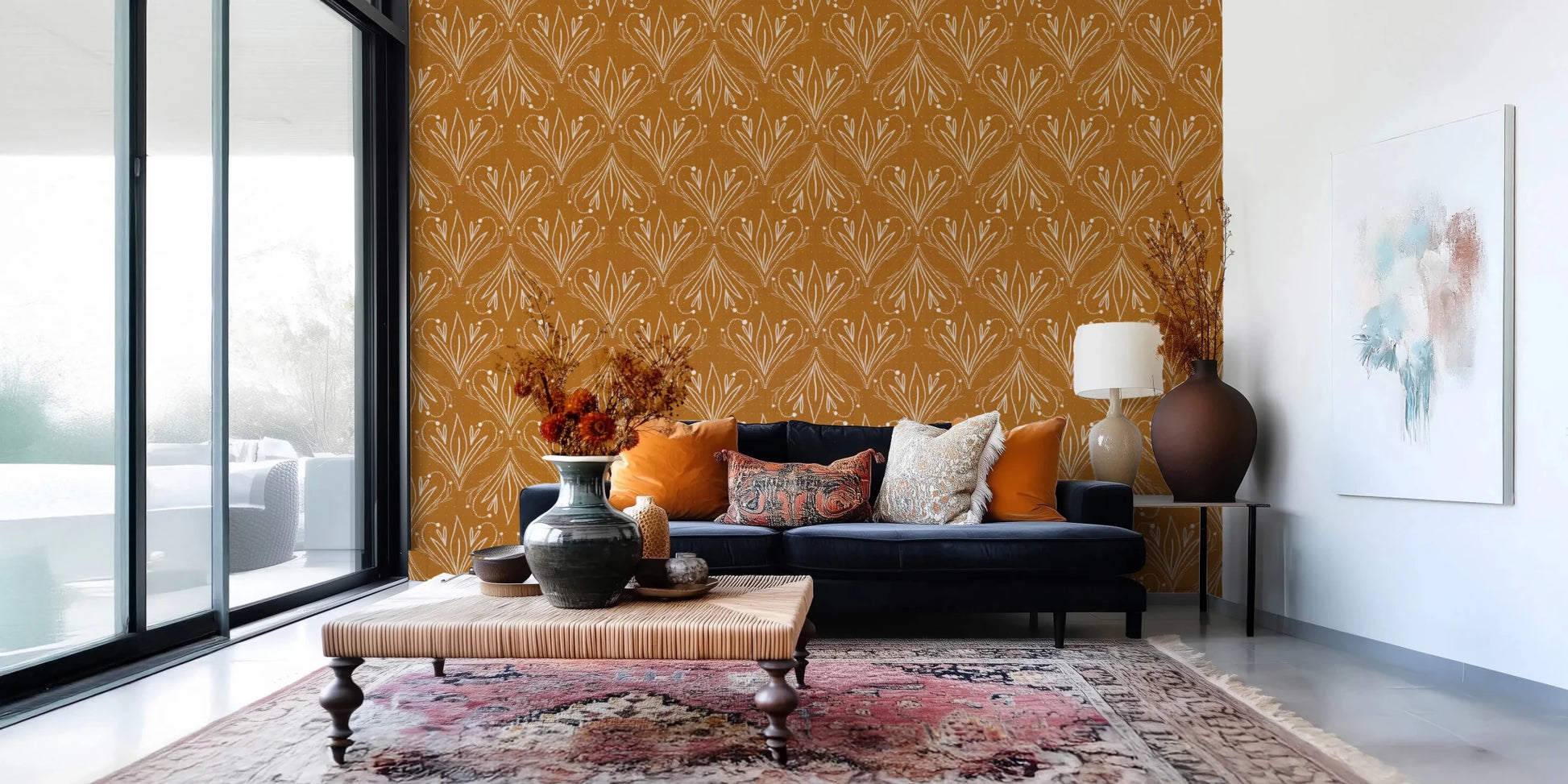 Boho Art Nouveau Folk Floral Mustard Gold wallpaper behind a navy sofa and woven ottoman in a bright living room