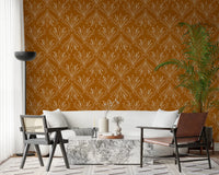 Boho Art Nouveau Folk Floral Mustard Gold wallpaper behind a cream sofa and marble table in a living room