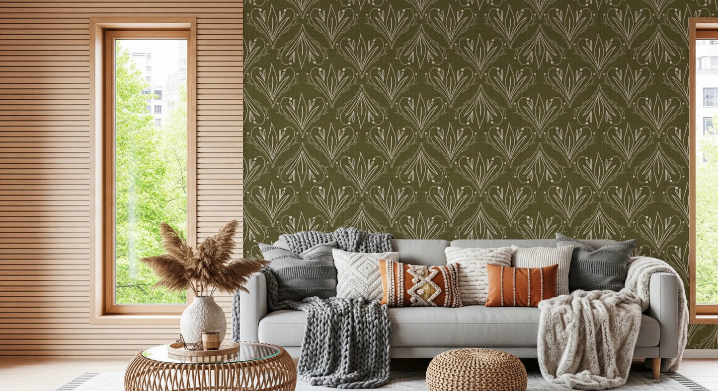 Boho Art Nouveau Folk Floral Olive Green wallpaper behind a grey sofa with boho cushions in a living room