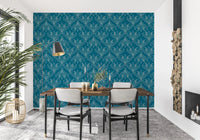Boho Art Nouveau Folk Floral Teal Blue wallpaper behind a wood dining table and black chairs in a dining room