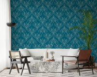 Boho Art Nouveau Folk Floral Teal Blue wallpaper behind a cream sofa and marble table in a living room