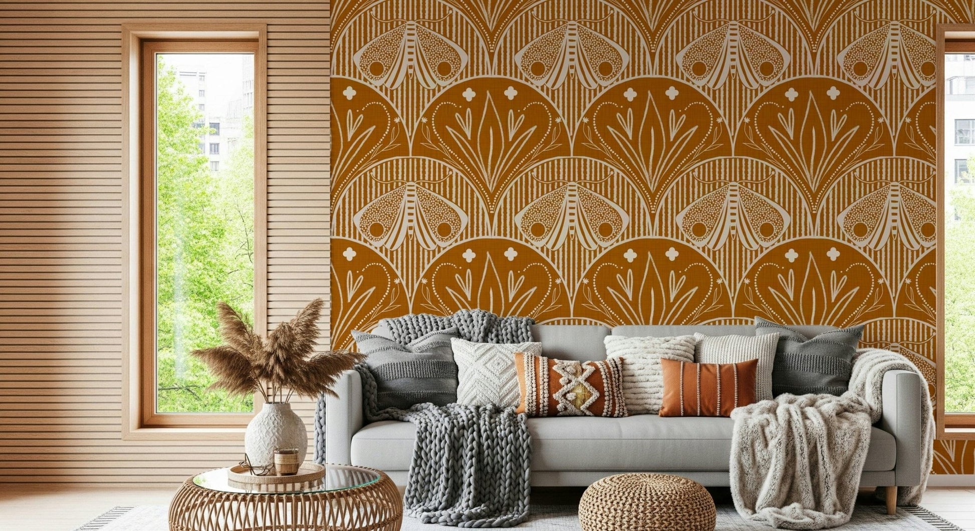 Boho Art Nouveau Scallop Butterfly Floral in Burnt Orange wallpaper mural behind a grey sofa with knit throws