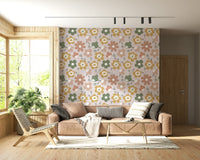 A playful boho floral wallpaper featuring oversized daisy-like shapes in gentle retro colors.