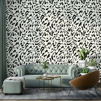 An angled shot of a wall with a brush doodle wallpaper


