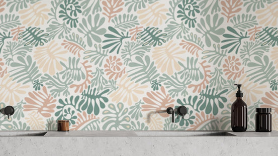 Botanical Elegance wallpaper of sage green and blush leaf shapes above a concrete vanity and black taps in a bathroom