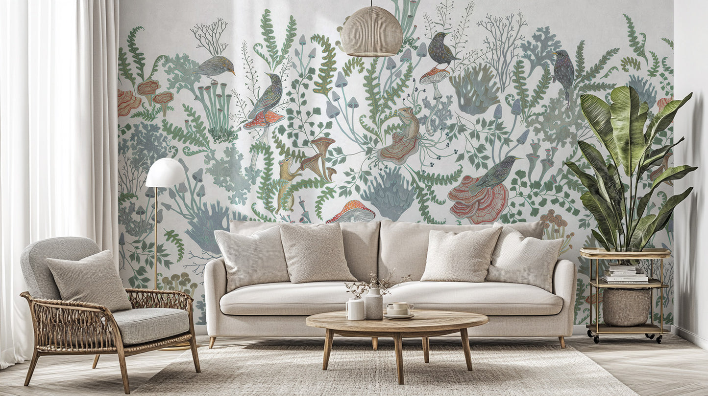 Botanical Nest Fresco wallpaper mural of sage plants and birds behind a cream sofa and rattan chair in a living room
