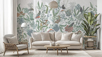 Botanical Nest Fresco wallpaper mural of sage plants and birds behind a cream sofa and rattan chair in a living room