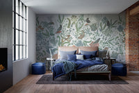 Botanical Nest Fresco wallpaper mural of sage ferns and birds above a peach headboard with navy bedding in a bedroom