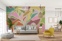 The mural is installed in a calm living room behind a simple, light-colored sofa.

