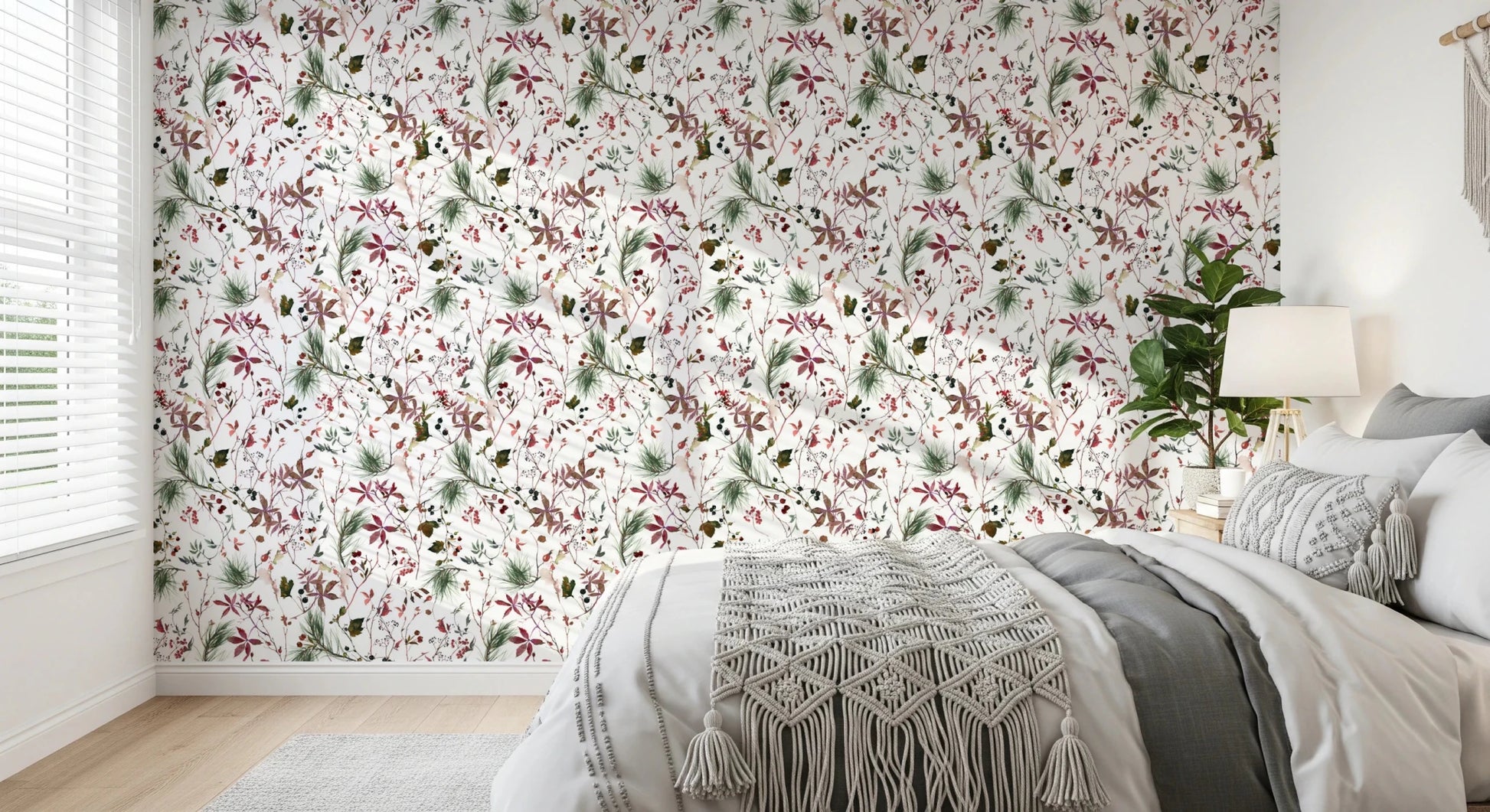Botanical Winter wallpaper mural behind a bed with grey bedding and a macrame throw in a bright bedroom