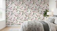 Botanical Winter wallpaper mural behind a bed with grey bedding and a macrame throw in a bright bedroom