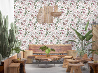 Botanical Winter wallpaper mural in a boho lounge with a live-edge wood bench, woven pendants and cacti