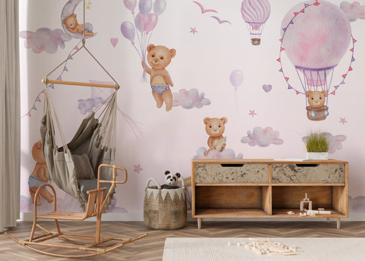 Bouncy Bear Sky Journey mural with watercolor teddy bears and pink hot-air balloons in a nursery with a hanging chair