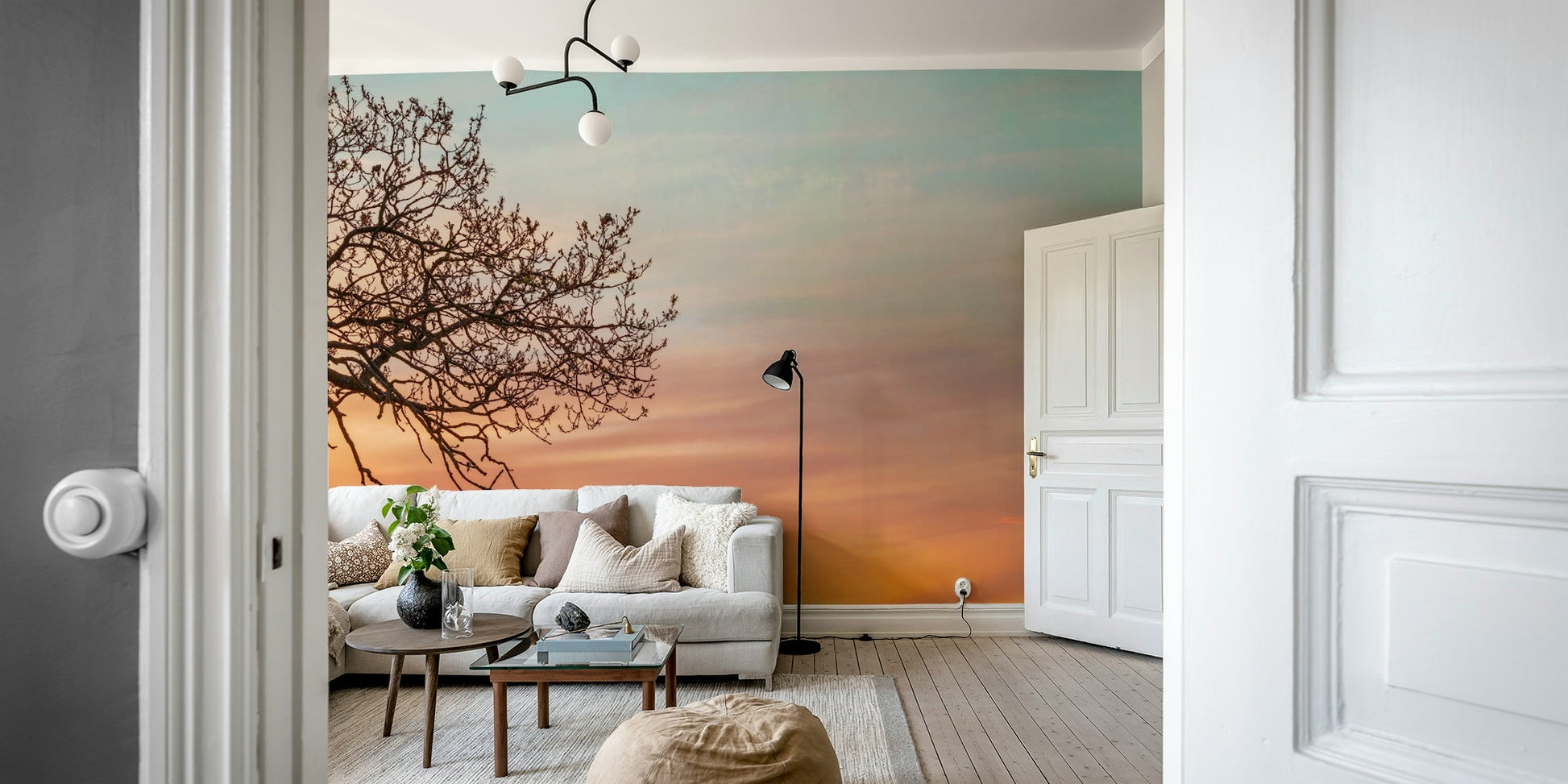 Warm gradient sunset with silhouetted tree

