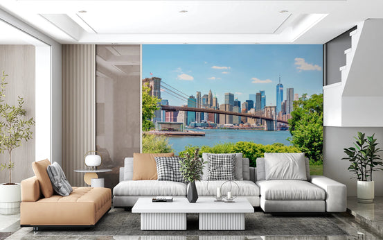 Bridge to Manhattan wall mural of the Brooklyn Bridge and city skyline behind a tan chaise and grey sectional sofa