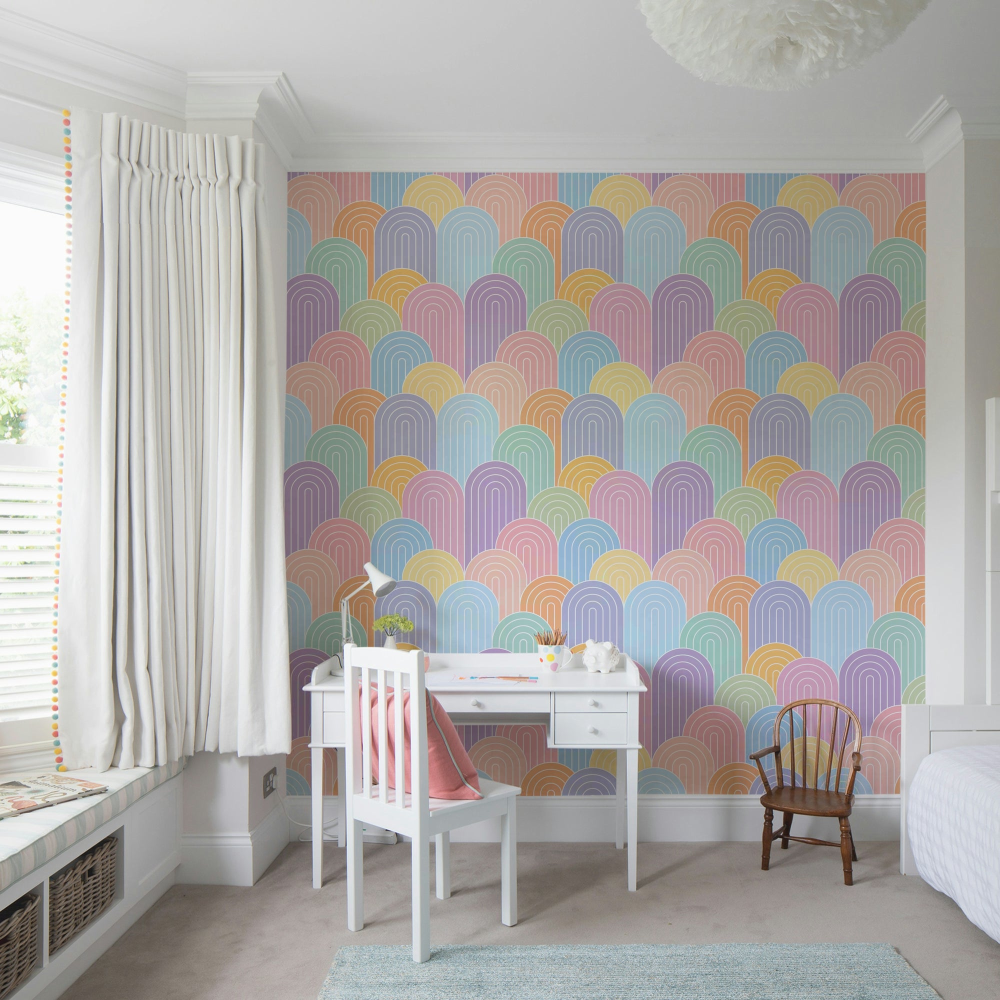 Bright Pastel Rainbows wallpaper mural behind a white desk and chair in a child's bedroom