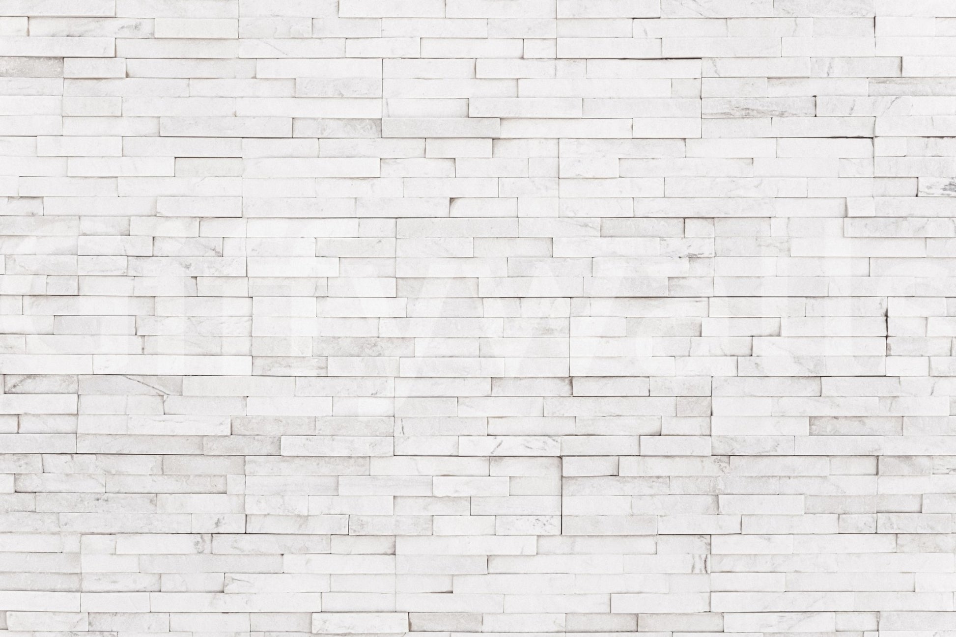 Bright Stacked Stone wall mural close-up showing the pattern detail of thin white stone tiles with grey veining