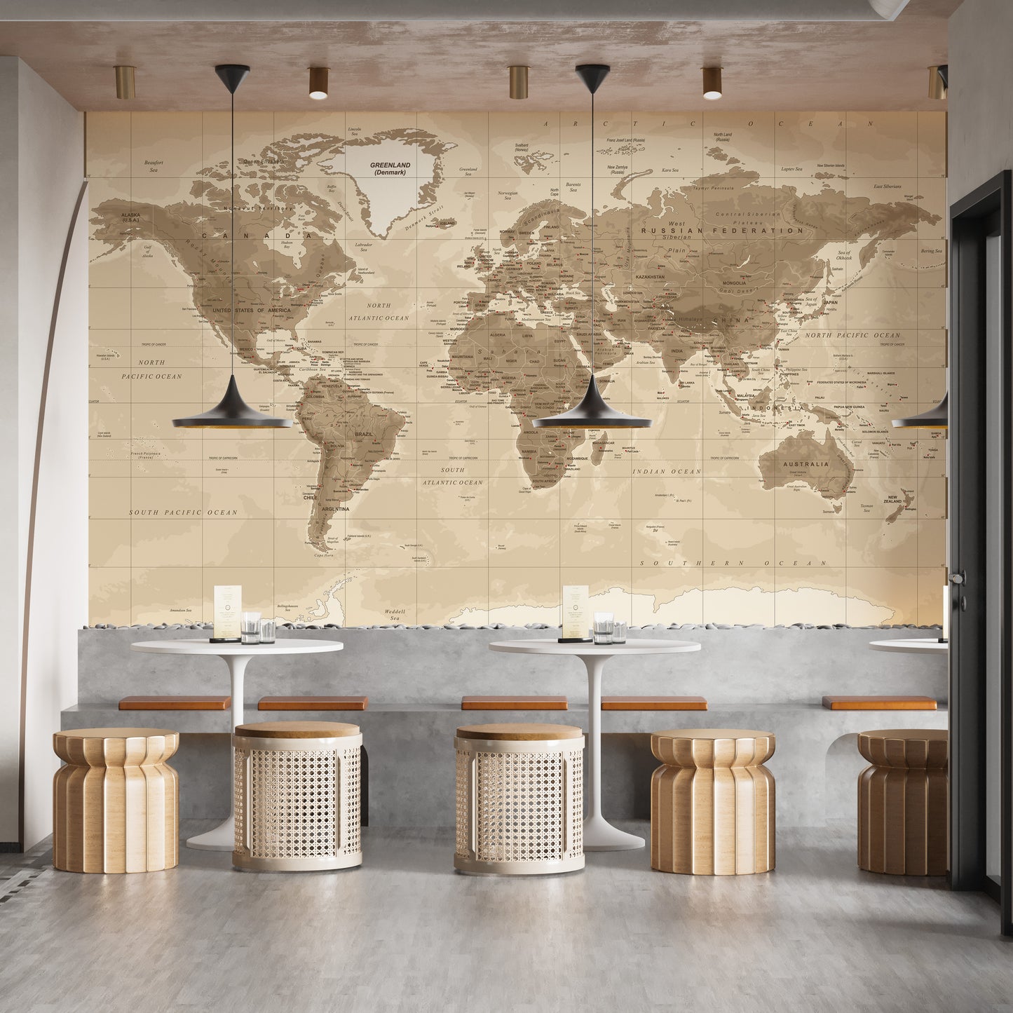 Brown Detailed Worldmap wall mural in sepia tones above white tables and rattan stools in a cafe seating area