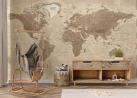 Brown Detailed Worldmap wall mural in sepia tones behind a rattan swing chair and wooden sideboard in a kids room