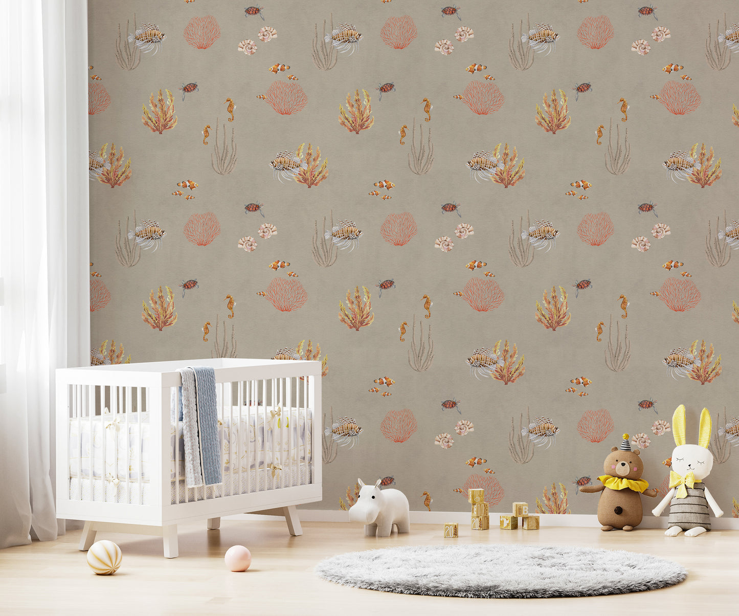 Brown Oceanic Wonders wallpaper over a white crib with a hippo toy and plush animals in a nursery