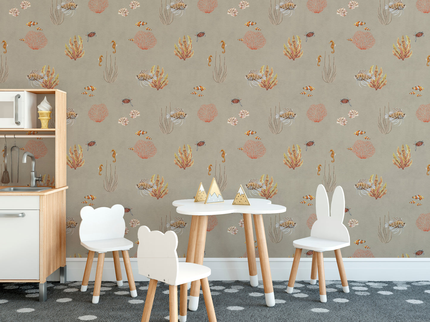 Brown Oceanic Wonders wallpaper by a white play kitchen and bear chairs on a dotted rug